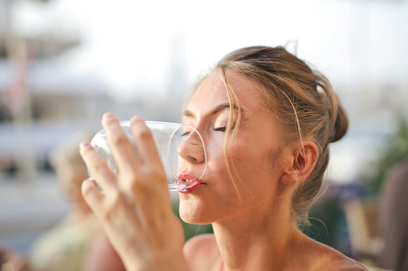 Woman drinking a glass of water.